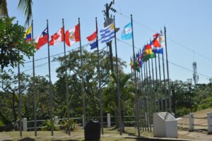 Various national flags displayed on poles outdoors.